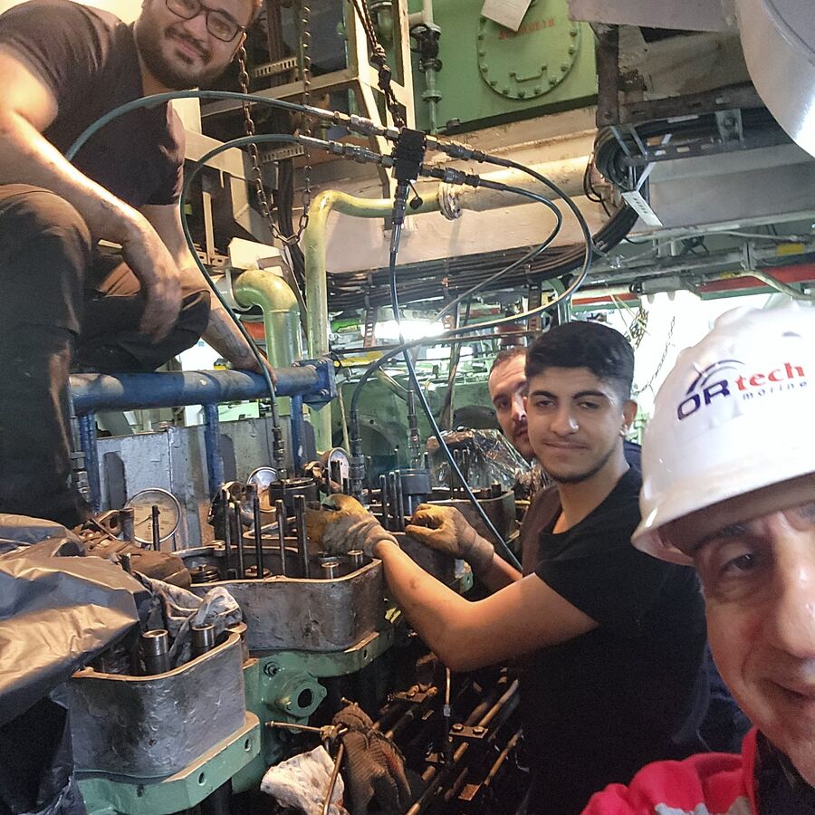 Ortech engineer and ship's crew overhauling a main engine